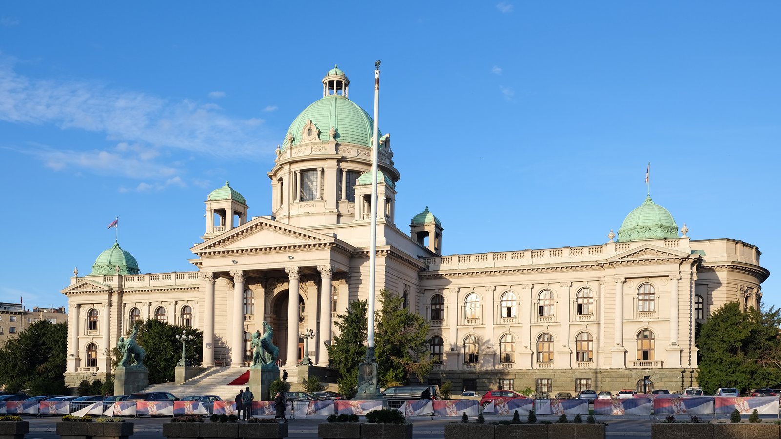 The House of the National Assembly of Serbia in Belgrade, a domed neoclassical building, under a blue sky